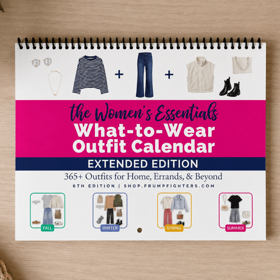 Spiral-bound printable outfit planner calendar for women lying flat on a wood desk, showing the four-season cover