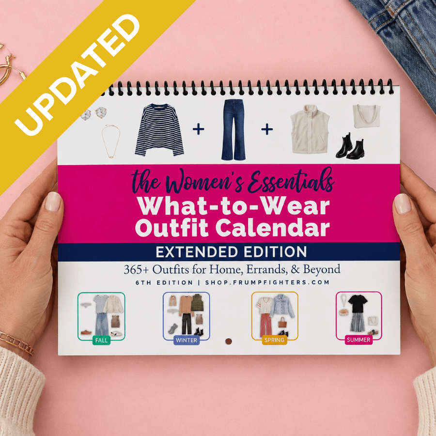 Extended Edition Women's Essentials What-to-Wear Outfit Calendar held in two hands over a pink background with jeans