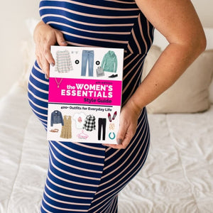 Pregnant expecting mom holding wardrobe style guide.