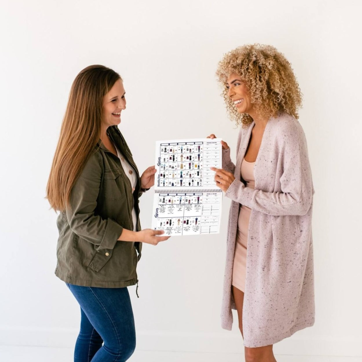 2 women holding open the The Women's Business What-to-Wear Outfit Calendar